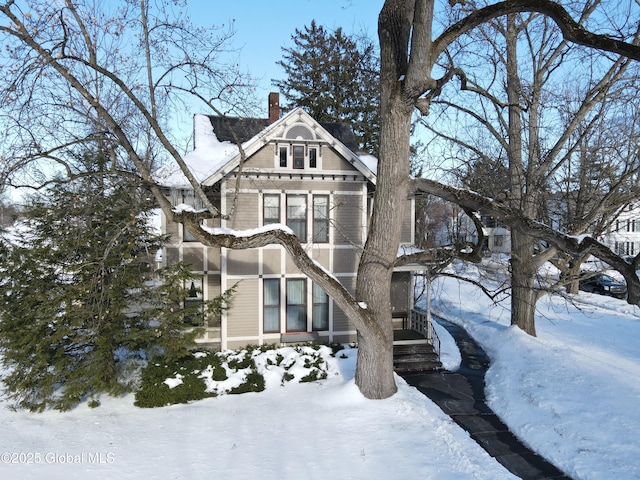 victorian-style house with a chimney