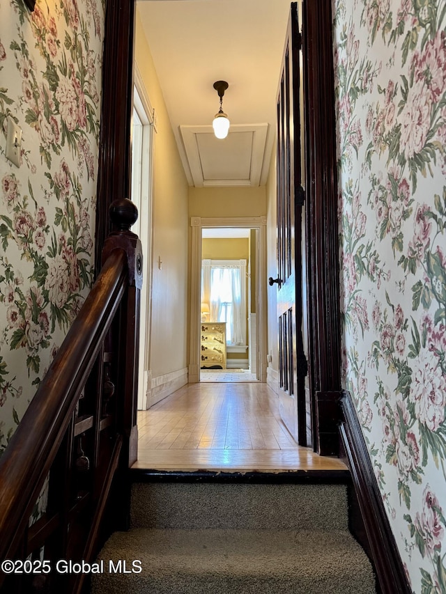 hallway featuring wallpapered walls