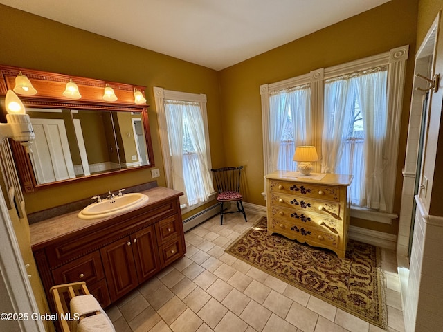 bathroom with a baseboard radiator, lofted ceiling, baseboards, and vanity