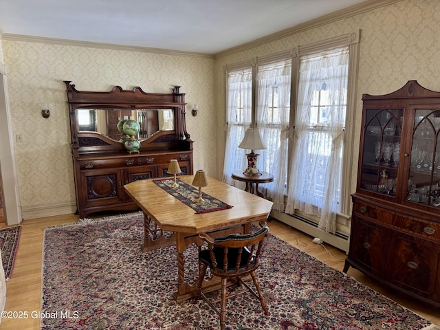 dining area with wallpapered walls, crown molding, light wood finished floors, a baseboard radiator, and baseboards