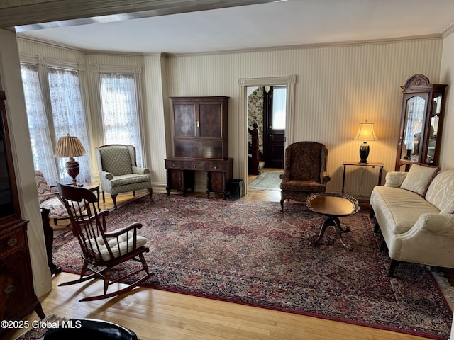 living room featuring crown molding and hardwood / wood-style floors