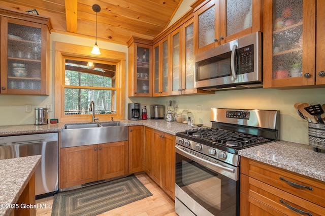 kitchen featuring light stone counters, brown cabinets, wooden ceiling, stainless steel appliances, and a sink