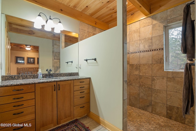 bathroom featuring vanity, beamed ceiling, tile patterned flooring, and walk in shower