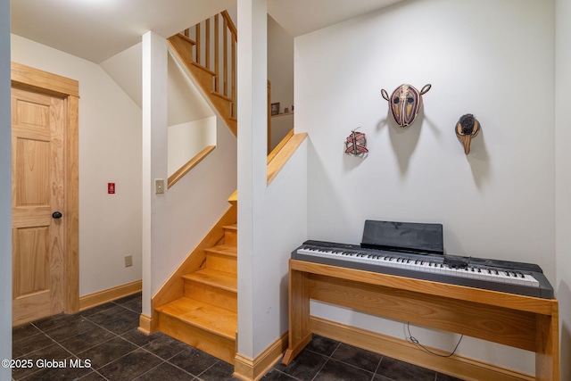 staircase featuring tile patterned flooring and baseboards