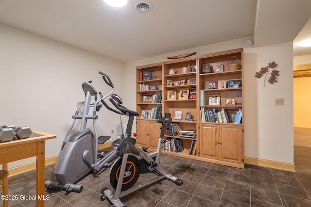 exercise area featuring baseboards and visible vents