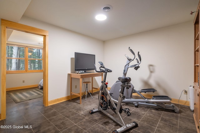 exercise room with visible vents and baseboards