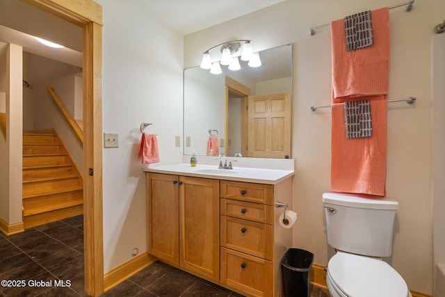 full bath featuring vanity, toilet, baseboards, and tile patterned flooring