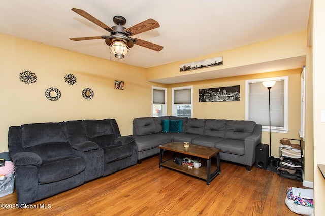 living area featuring wood finished floors and ceiling fan