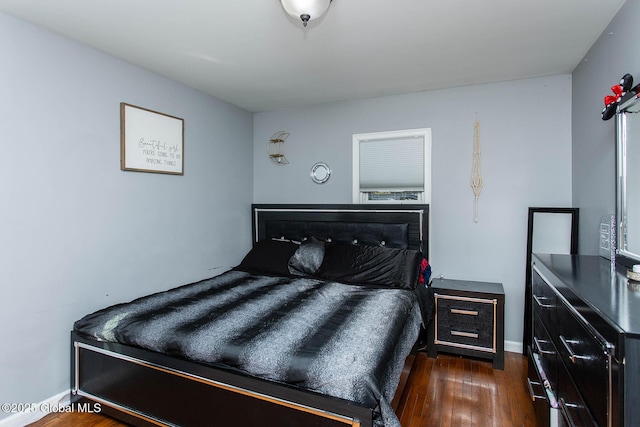 bedroom featuring dark wood finished floors