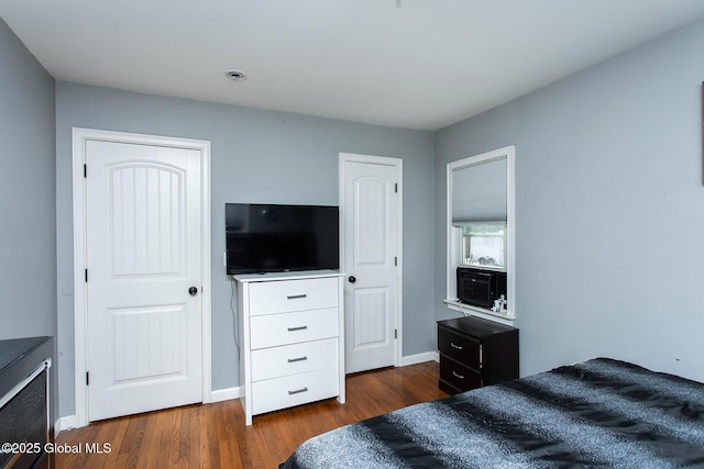 bedroom with baseboards and dark wood-style floors