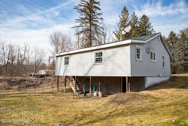 exterior space with stairway and a yard