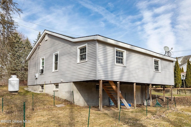 rear view of house featuring stairs and fence