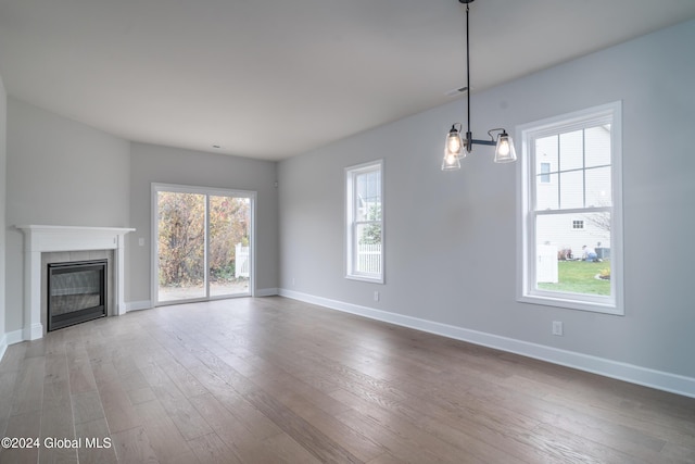 44 Priddle Ln, Colonie, NY 12110 - unfurnished living room featuring visible vents, a fireplace, baseboards, and wood finished floors