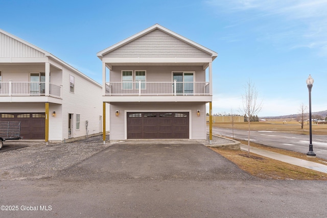 view of front of home with aphalt driveway and an attached garage