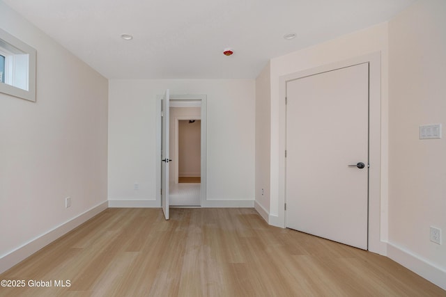 unfurnished bedroom featuring baseboards and light wood-style floors