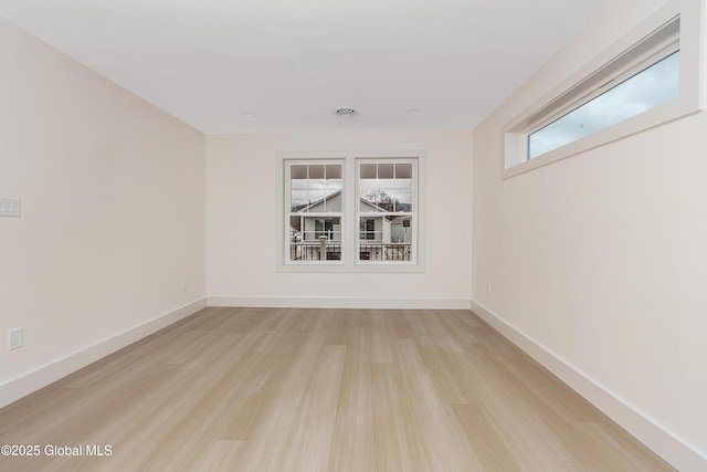 unfurnished room featuring light wood-style flooring and baseboards