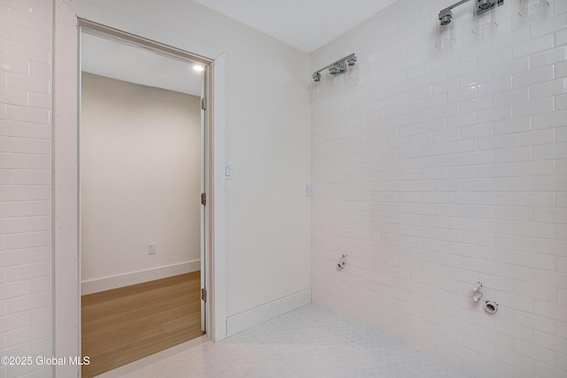 bathroom featuring baseboards and wood finished floors