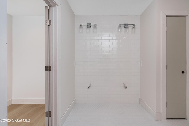 bathroom with wood finished floors and baseboards