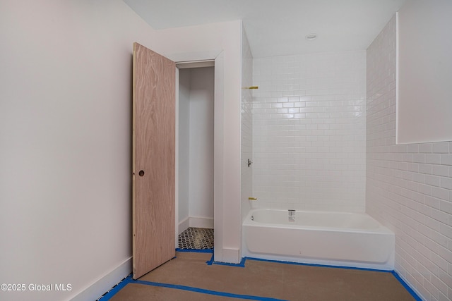 full bathroom featuring tile patterned floors, tile walls, and shower / bath combination