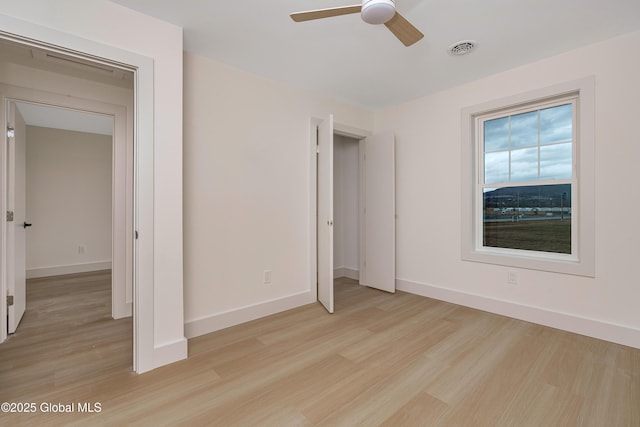 unfurnished bedroom featuring visible vents, baseboards, and light wood finished floors