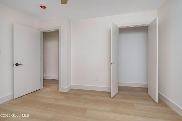 unfurnished bedroom featuring light wood-style flooring and baseboards