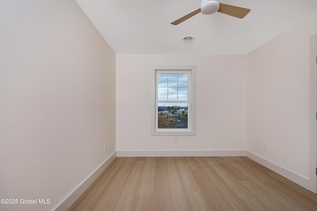 unfurnished room featuring visible vents, ceiling fan, light wood-type flooring, and baseboards