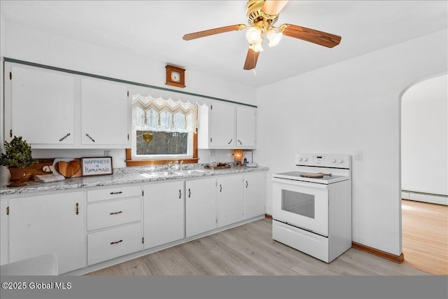 kitchen with light wood-style flooring, arched walkways, a sink, electric stove, and white cabinetry