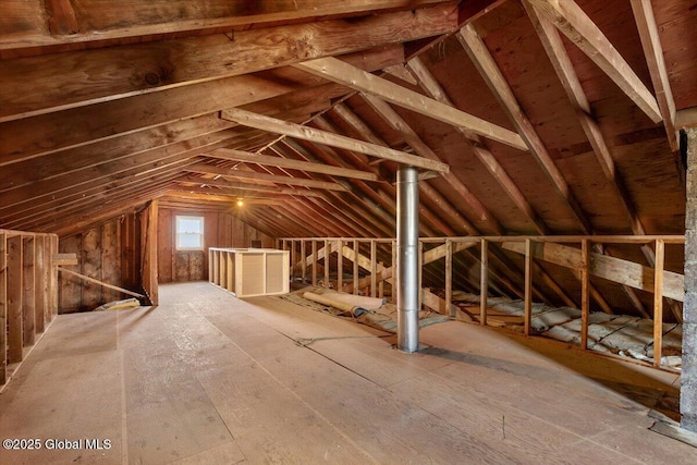 unfinished attic with an upstairs landing