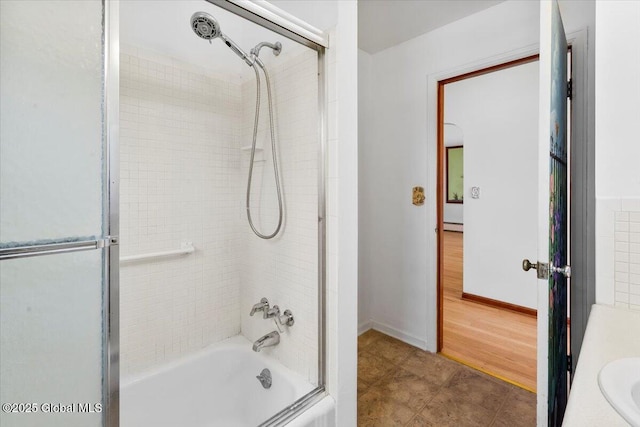 full bathroom with baseboards and bathing tub / shower combination