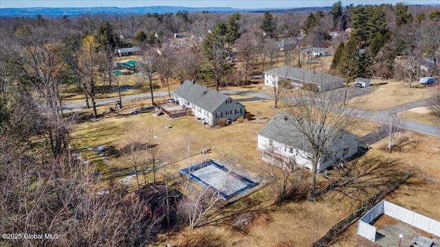 birds eye view of property featuring a wooded view