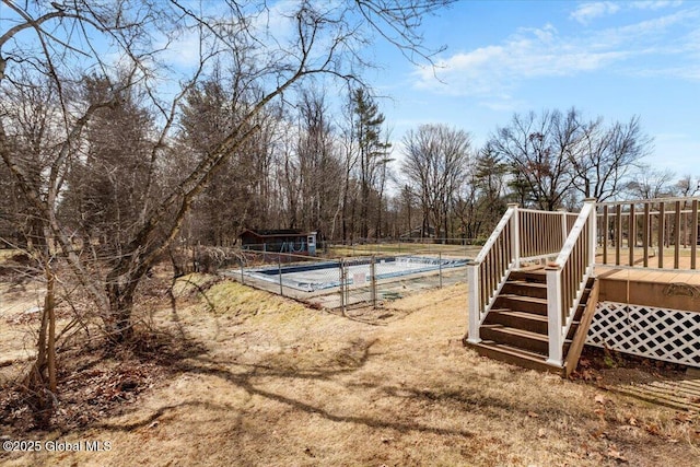 view of pool featuring a deck, a fenced in pool, and fence