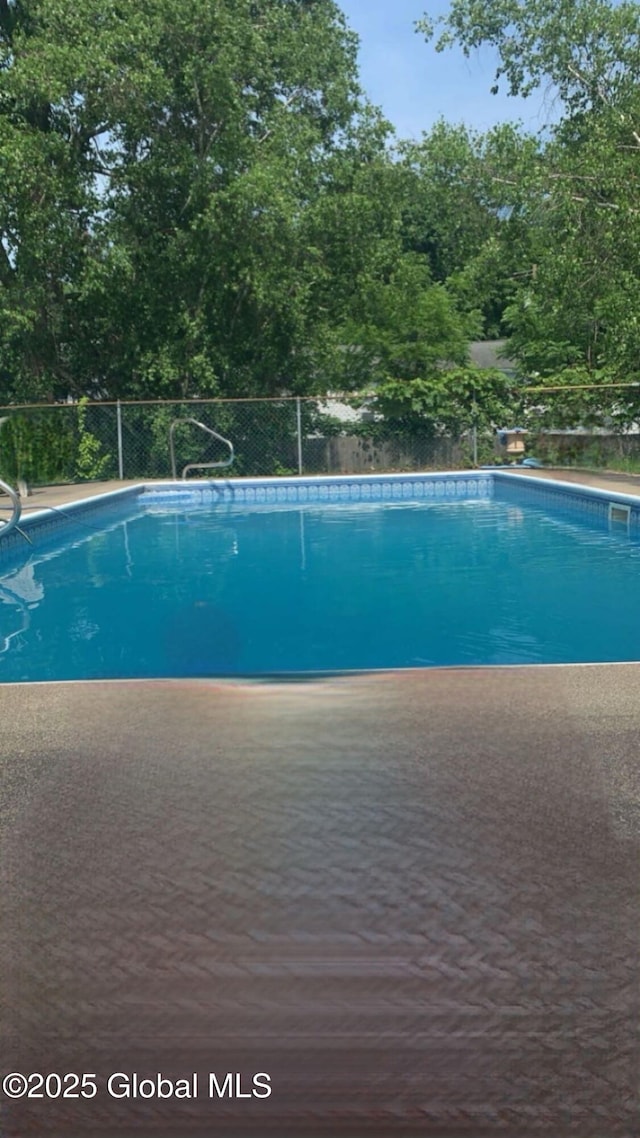 view of pool featuring a fenced in pool and fence