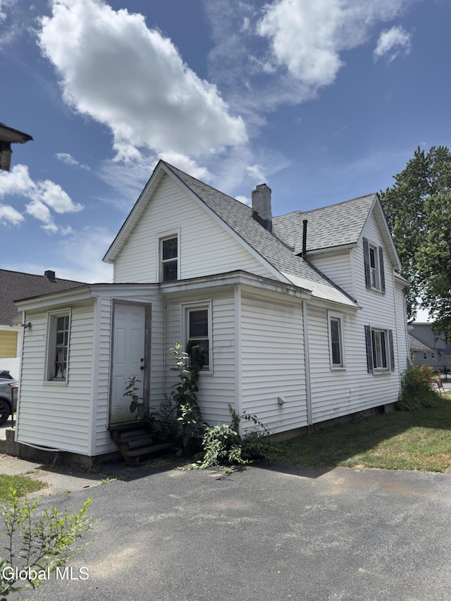 3144 N Thompson St, Rotterdam, NY 12306 - view of home's exterior featuring entry steps, a chimney, and a shingled roof