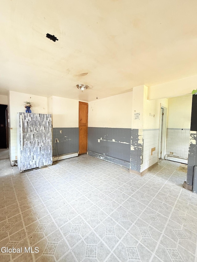 3144 N Thompson St, Rotterdam, NY 12306 - unfurnished living room with a wainscoted wall and baseboard heating