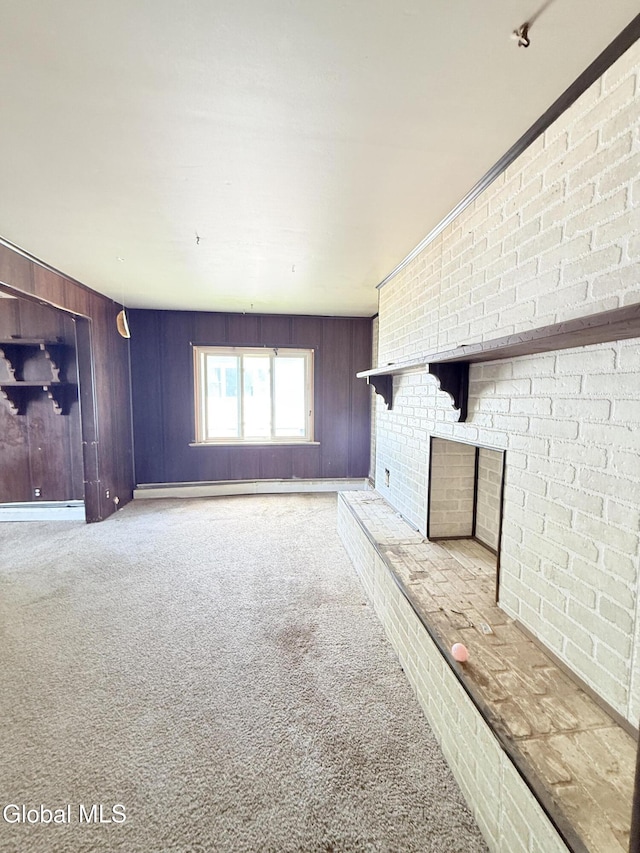 3144 N Thompson St, Rotterdam, NY 12306 - unfurnished living room featuring carpet floors, a fireplace, and wood walls
