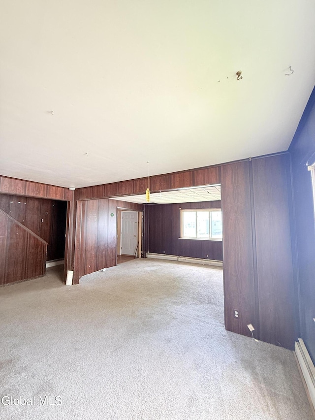 3144 N Thompson St, Rotterdam, NY 12306 - carpeted empty room featuring wood walls and a baseboard radiator