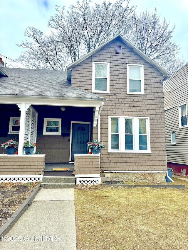 view of front facade featuring a porch and roof with shingles