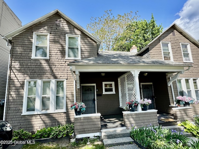 21 Bonheim St, Albany, NY 12204 - view of front of home with a porch, a chimney, and roof with shingles