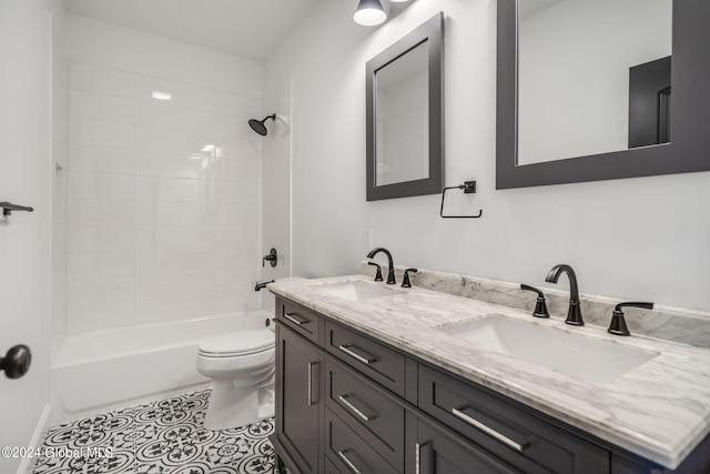 full bath with tile patterned floors, shower / washtub combination, toilet, and a sink