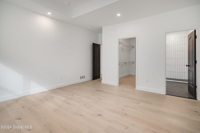 unfurnished bedroom with recessed lighting, baseboards, and light wood finished floors