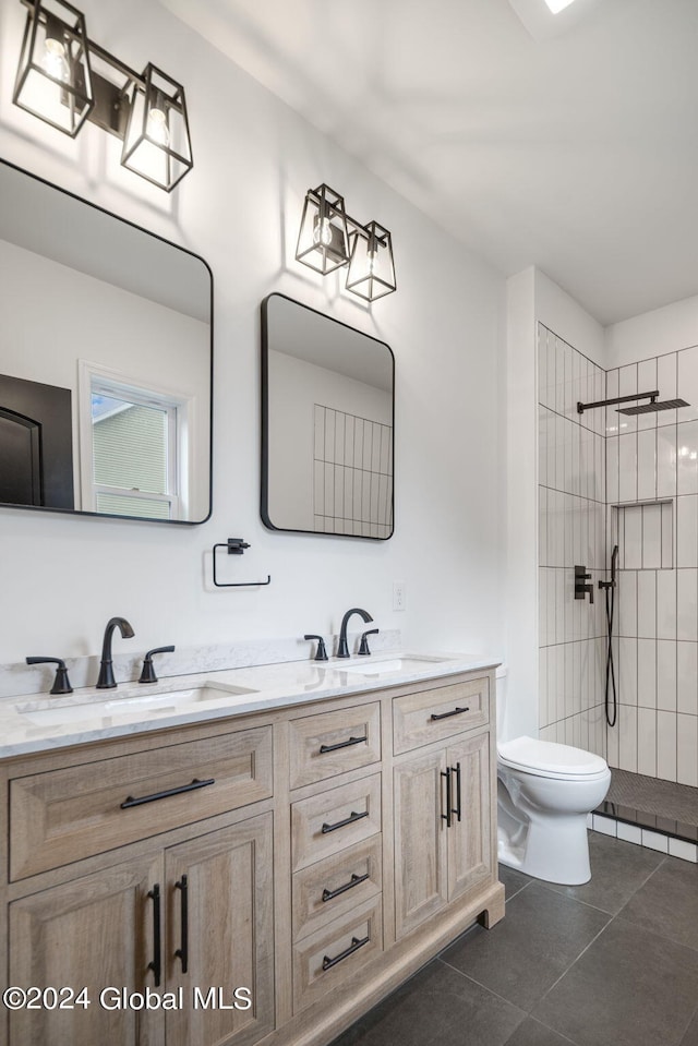 full bath with a sink, toilet, tile patterned flooring, and a walk in shower