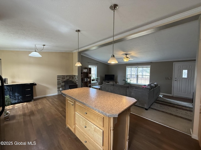 kitchen featuring a ceiling fan, a textured ceiling, a kitchen island, dark wood-style flooring, and vaulted ceiling