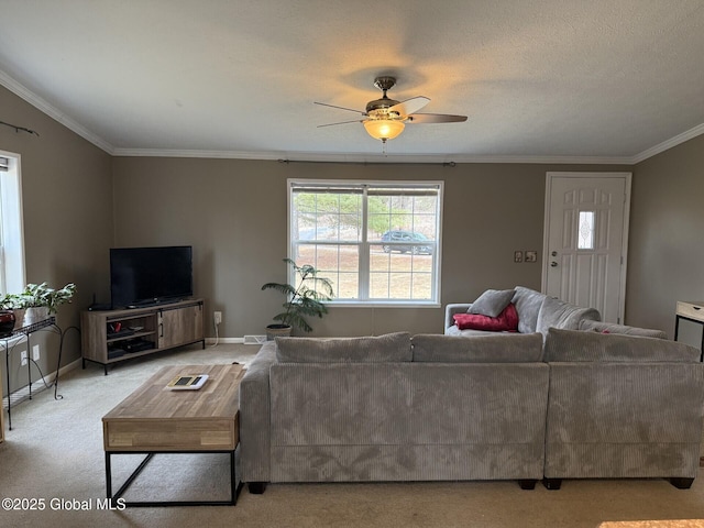 living room with baseboards, carpet floors, ceiling fan, and ornamental molding