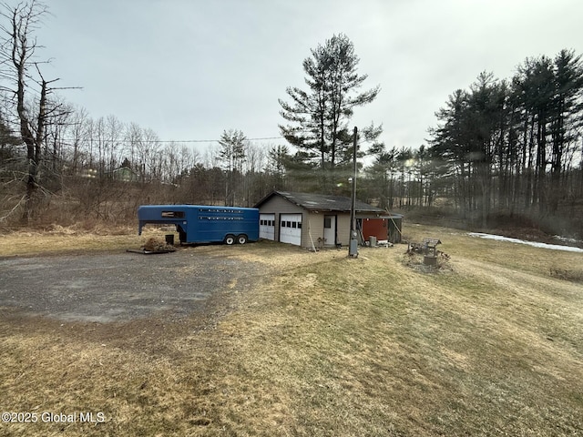 exterior space with driveway and an outdoor structure