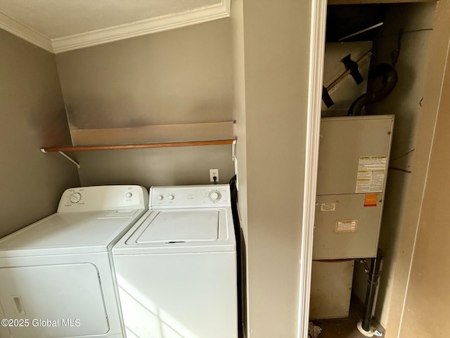 washroom with laundry area, ornamental molding, and separate washer and dryer