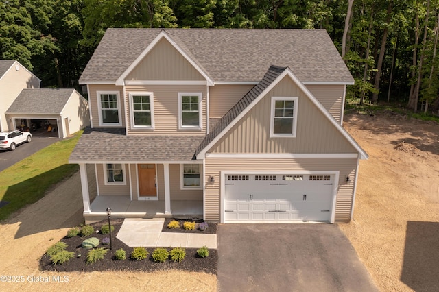 159 Anthony Rd, Halfmoon, NY 12065 - traditional-style house with a porch, roof with shingles, driveway, board and batten siding, and an attached garage