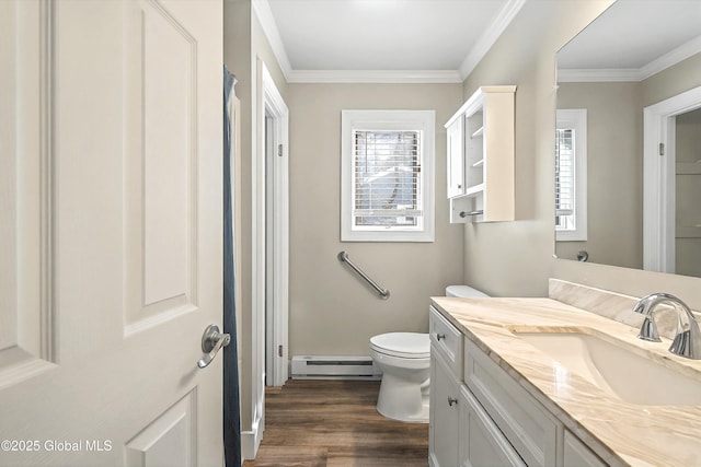 bathroom featuring vanity, wood finished floors, a baseboard radiator, crown molding, and toilet