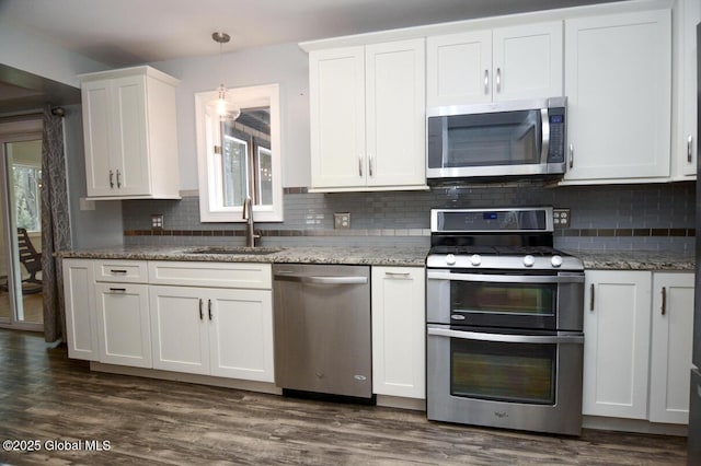 kitchen featuring dark wood finished floors, white cabinets, appliances with stainless steel finishes, and a sink