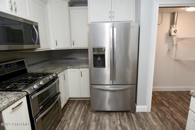 kitchen featuring white cabinetry, light stone countertops, dark wood-style floors, and appliances with stainless steel finishes