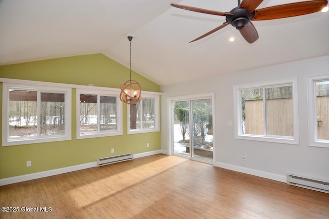 interior space featuring a baseboard heating unit, baseboard heating, wood finished floors, and vaulted ceiling